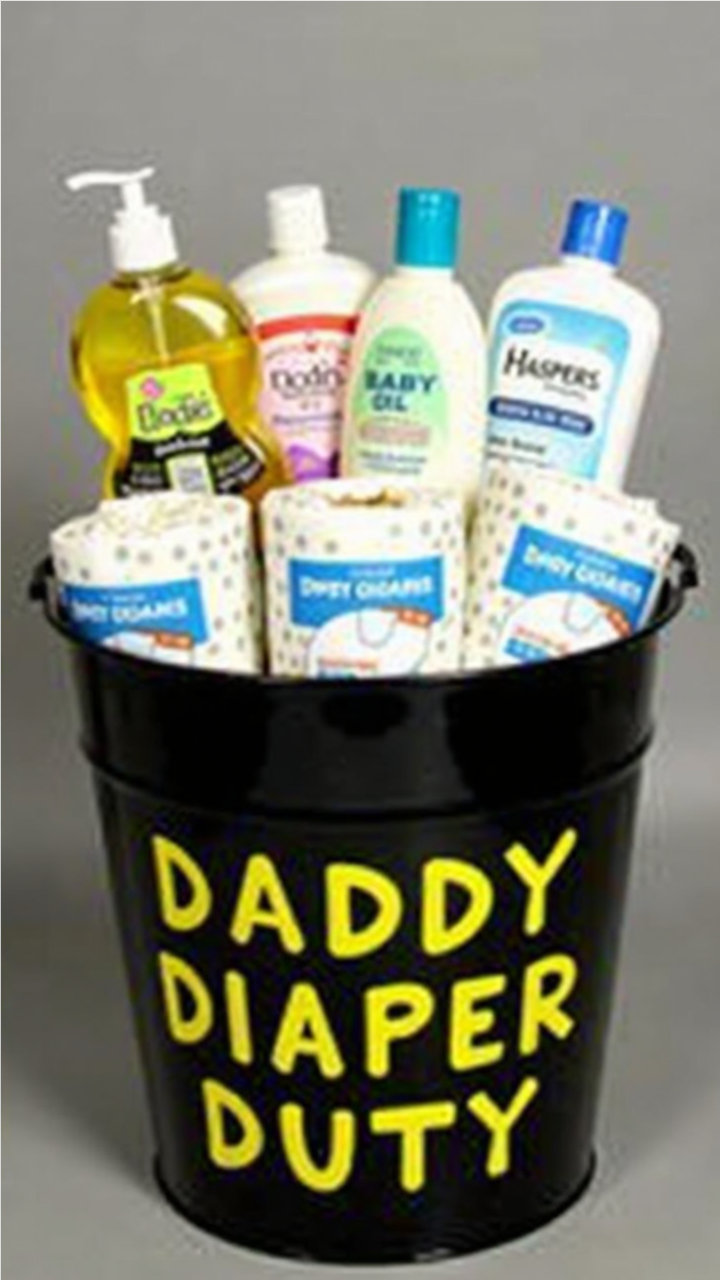 A black bucket labeled 'Daddy Diaper Duty' in bold yellow letters, filled with baby essentials such as diapers, baby oil, lotion, soap, and wipes. A humorous and practical Father's Day gift basket for new dads